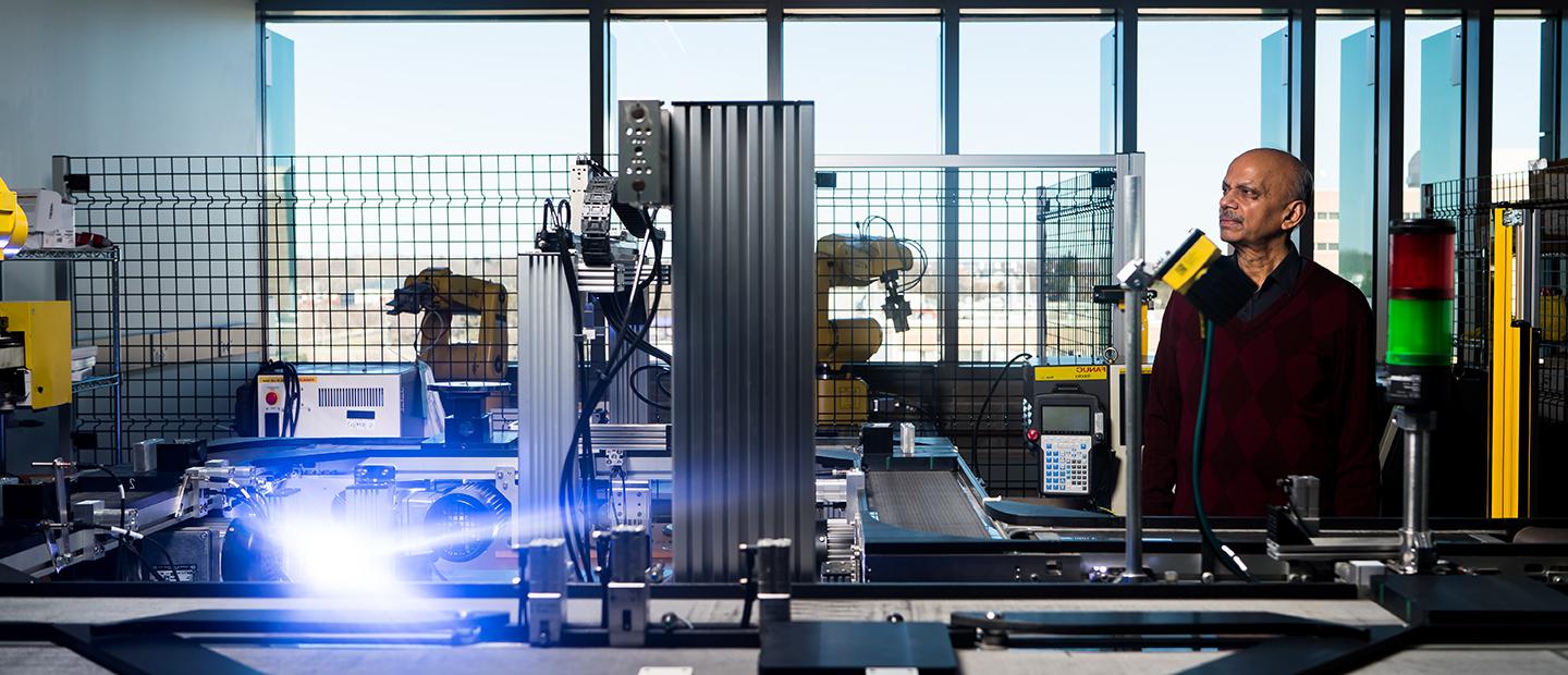 A man in an industrial/mechanical lab